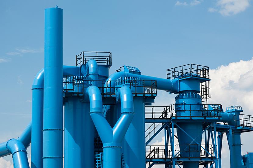 exterior shot of industrial facilitys blue pipes