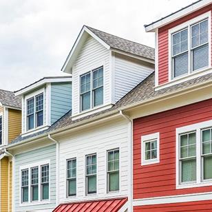 row of colorful red yellow blue white green painted townhouses